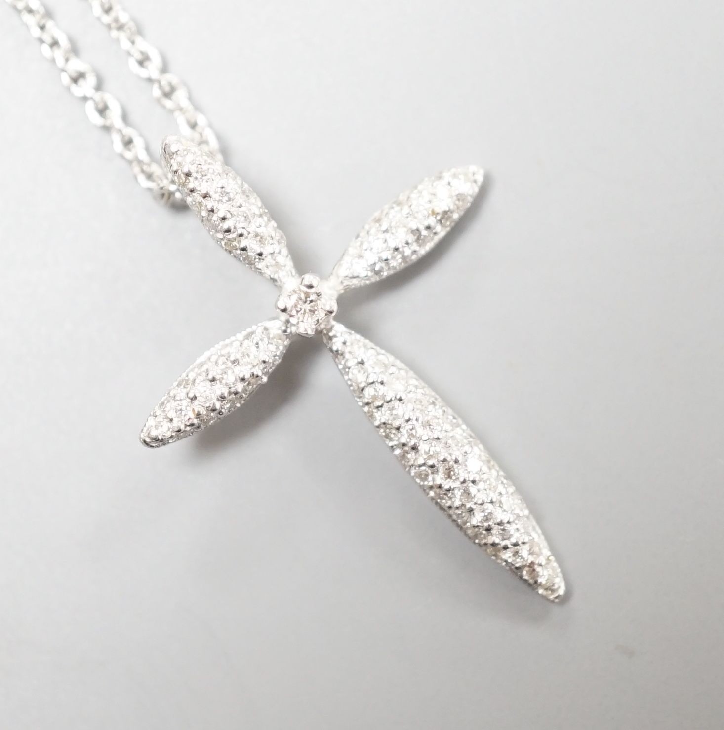 A modern 18ct white gold and pave set diamond cross pendant, 26mm, on an 18ct white gold fine link chain, 40cm, gross weight 4.9 grams
